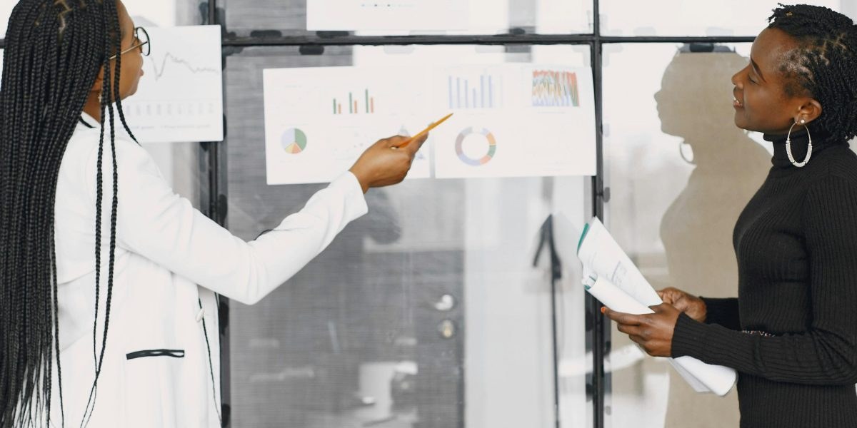Analysts reviewing newspaper ranking charts