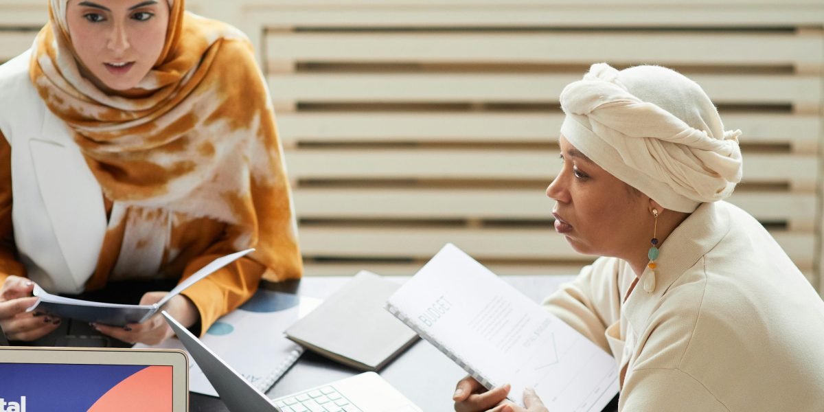 A group of professionals discussing and analyzing advertising strategies in a modern office setting.