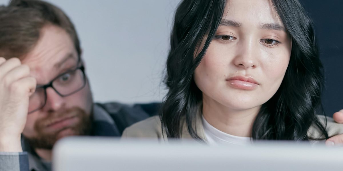 A person looking concerned or surprised while reviewing content, reflecting the risks of problematic ad placements.