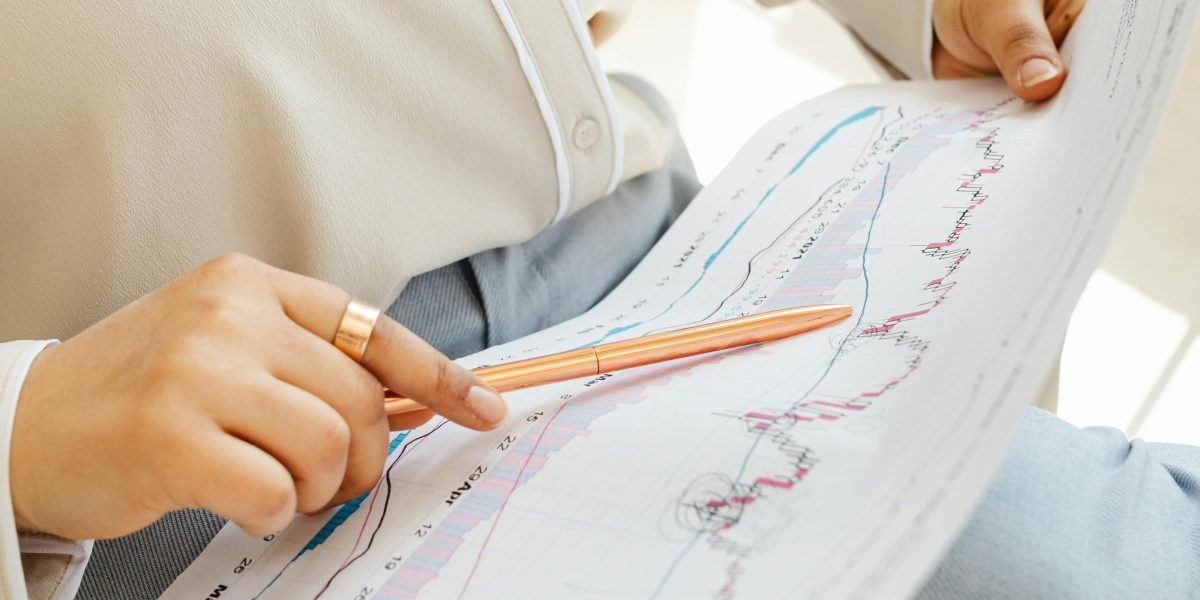 A person intently analyzes a detailed report or spreadsheet, focusing on data-driven insights.