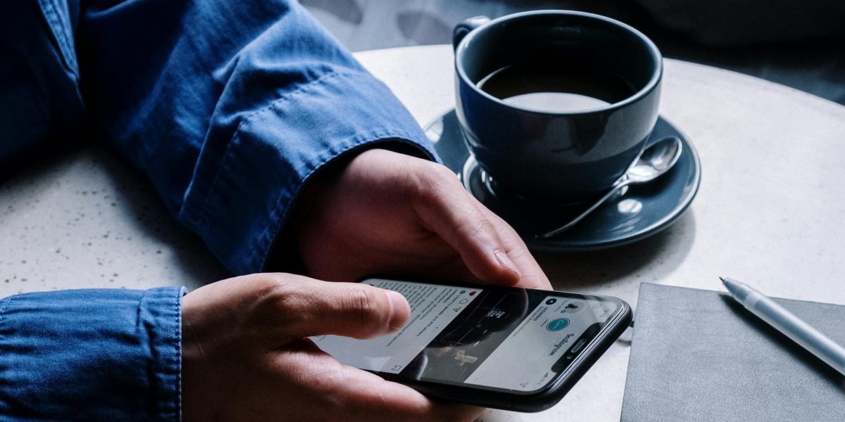 A person consuming news on a mobile phone, reflecting the shift from print to digital readership.