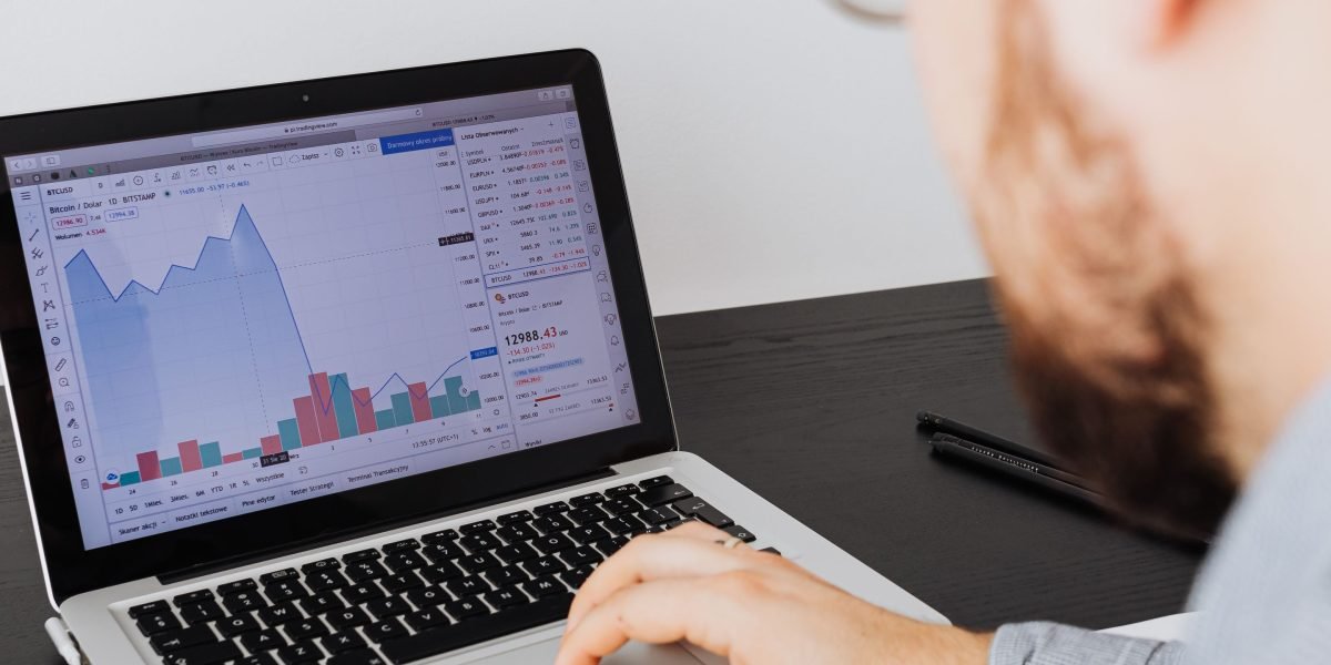 A professional meticulously reviews digital metric reports to assess a news outlet's online performance and audience reach.
