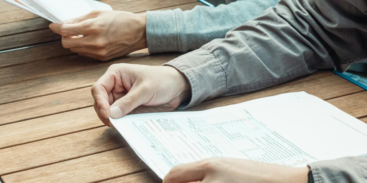 A media professional reviews various documents and data points to make informed decisions.