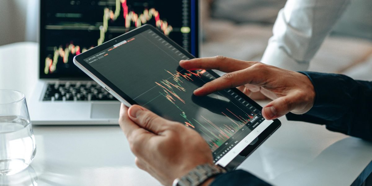 A professional meticulously analyzes a data dashboard to vet news outlets for brand safety.