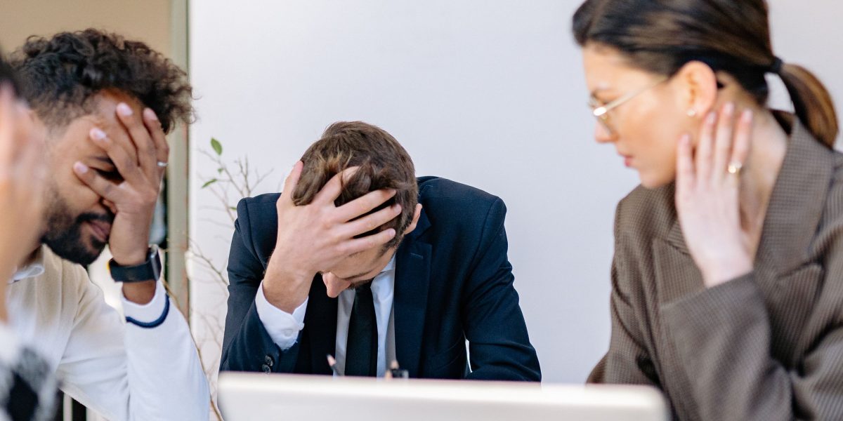 A team looking concerned during a meeting, representing the risks associated with poor ad placement and brand reputation.