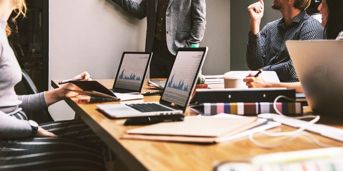 A business team in a meeting, intently discussing brand strategy and reputation, highlighting the stakes of media credibility.
