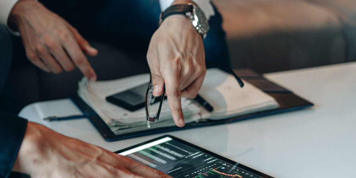 A person analyzing charts and data, representing the careful review needed for brand safety and risk mitigation.
