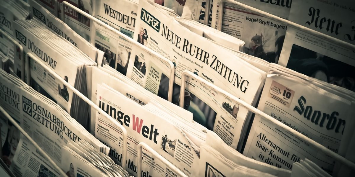 A person intently reading a newspaper, symbolizing the critical need for reliable information in today's society.
