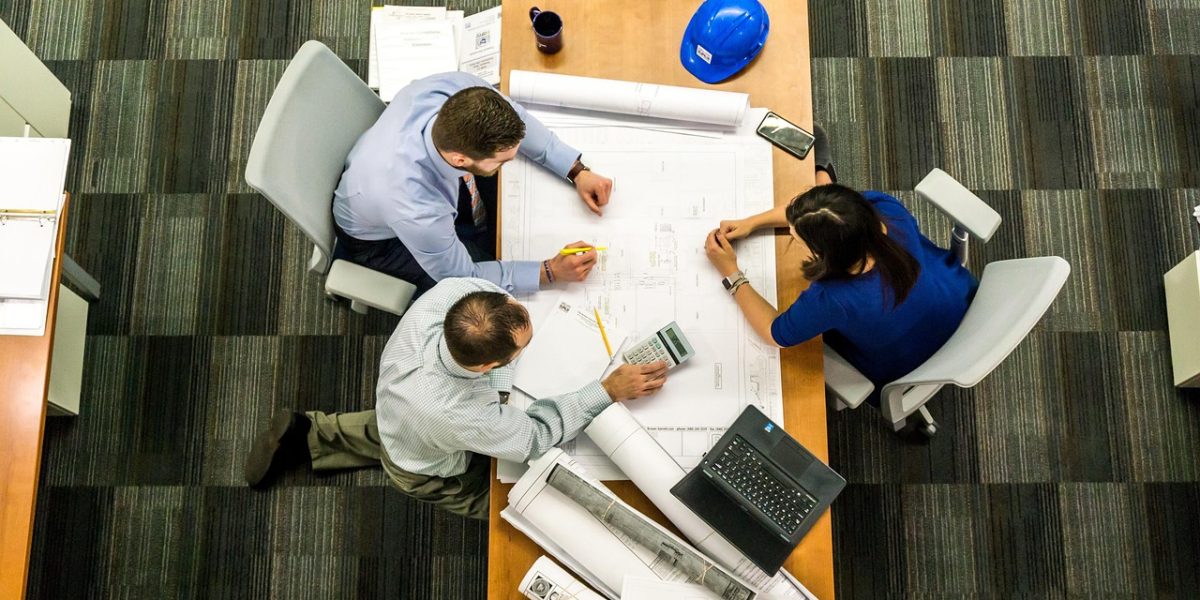 A marketing team in a meeting, using data and insights to make strategic decisions about media placements.