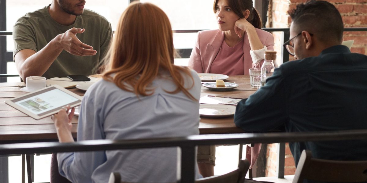 People engaged in a discussion, symbolizing how shared news narratives can create echo chambers and shape public opinion.
