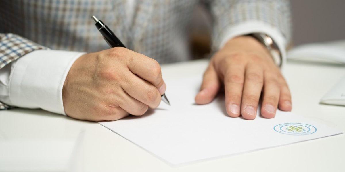 An individual reviewing financial documents, illustrating the importance of understanding cost and ROI for education.