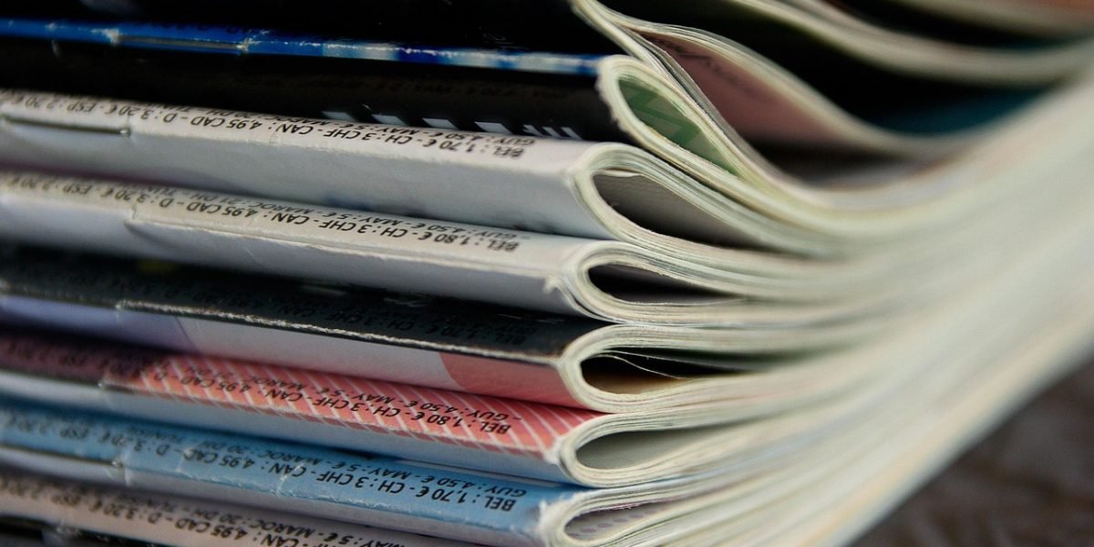 A person engages with a printed newspaper, highlighting the enduring human connection to traditional news formats.