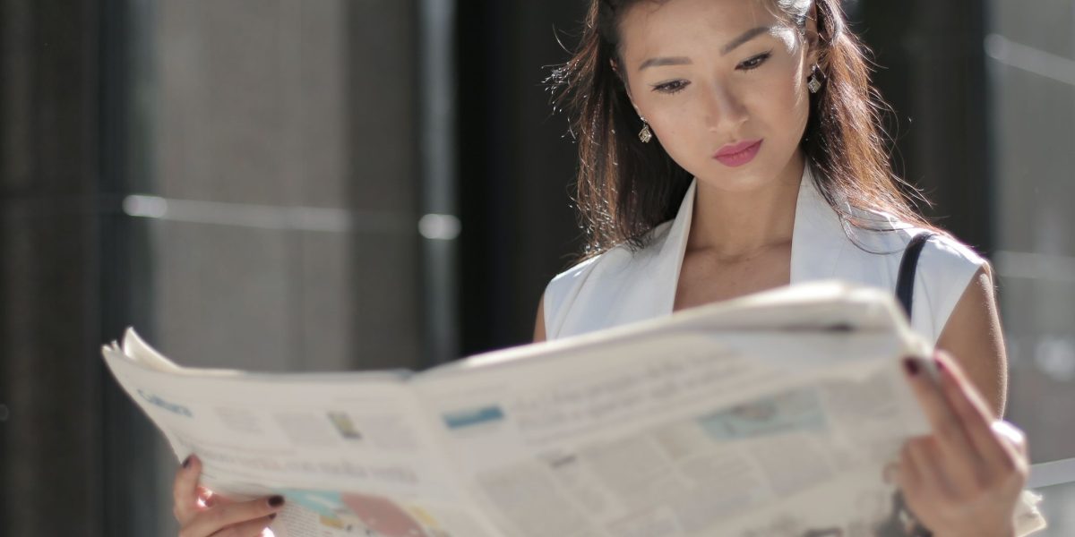 A person engaged in critically reading news content, reflecting thoughtful consumption.