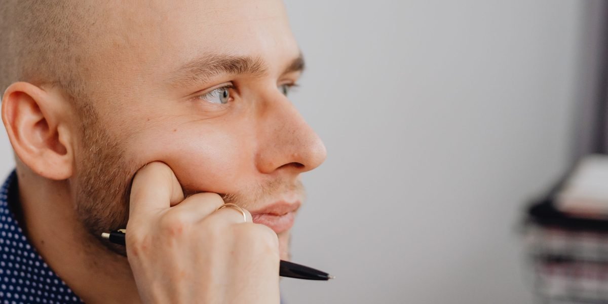 A professional contemplating choices, symbolizing the decision-making process for advertising channels.