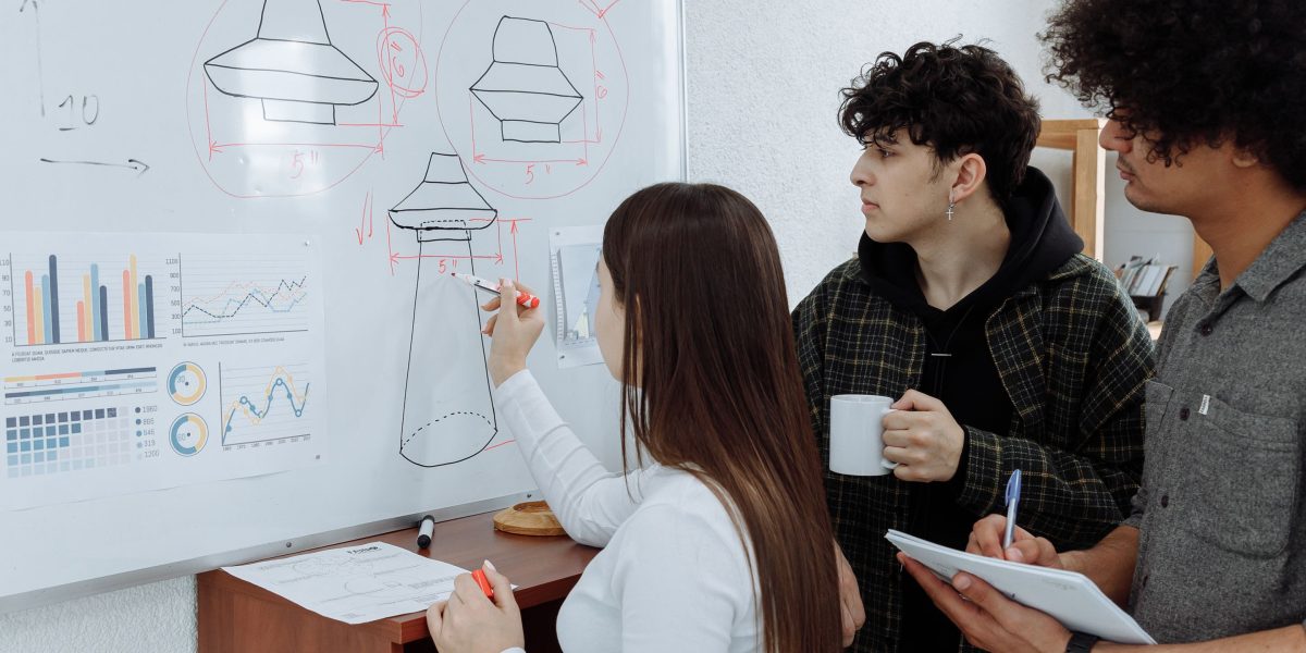 A team collaborating around a whiteboard, developing creative strategies for an advertising campaign.