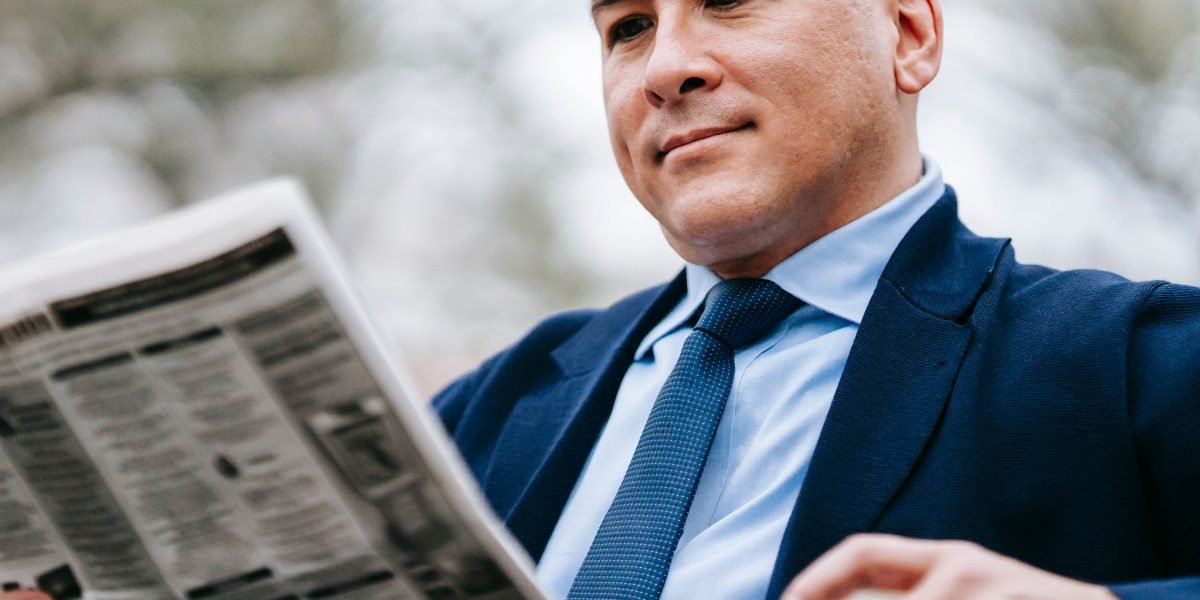 A person engaging thoughtfully with news content, representing the challenge of discerning reliable sources.