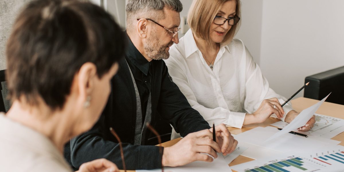 A team of professionals discusses various advertising strategies and their distinctions.
