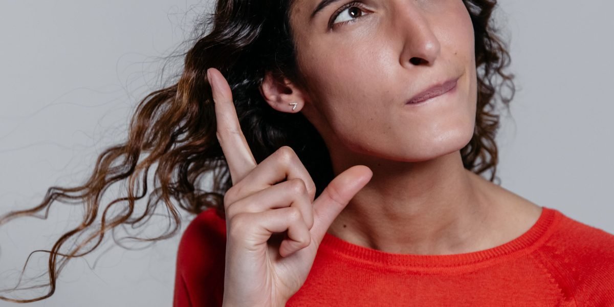 A person thoughtfully considering options, symbolizing the decision-making process for choosing Outlook list types.