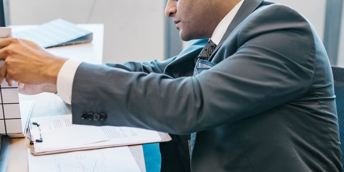 A small business owner diligently managing client data, perhaps on a tablet or a notebook, representing contact import.