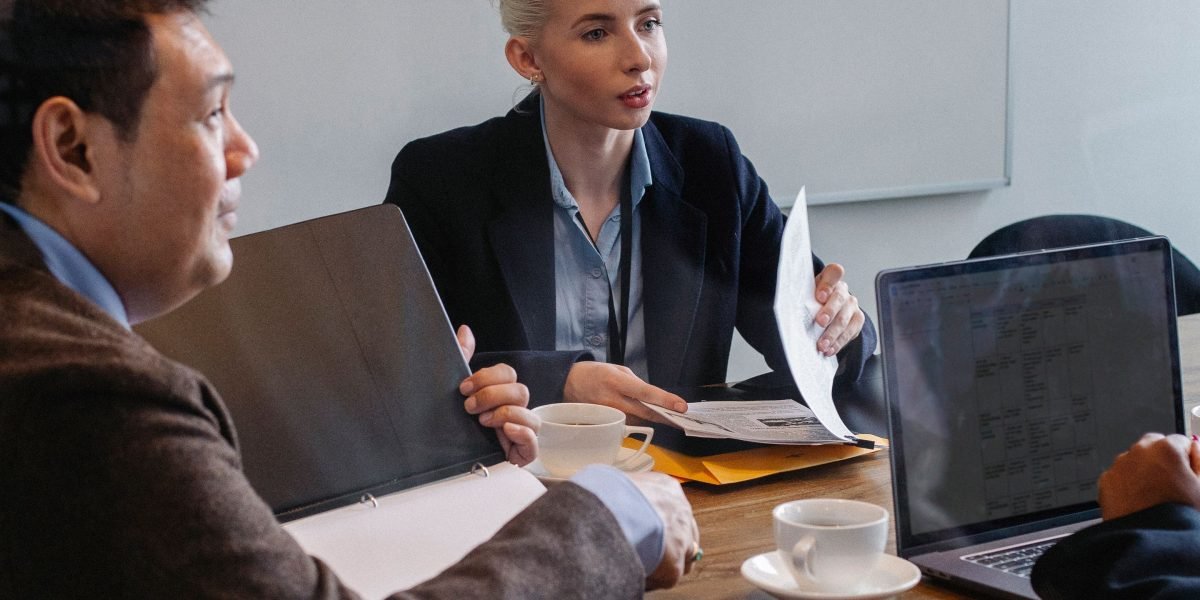 A group of professionals discussing brand safety and reputation management in advertising placements.